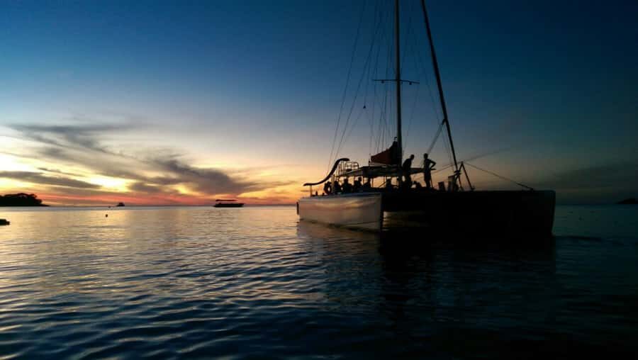 Grand Bay: BBQ Dinner on Catamaran & Short Sunset Tour - The Timing Twist: plan for a short cruise, then music onboard
