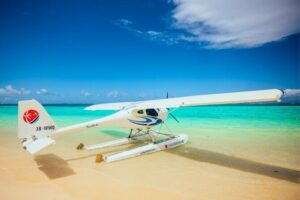 Seaplane Tours over the turquoise lagoon of the East of Mauritius - Île aux Cerfs from above: white sand, lagoon color, and a golf course